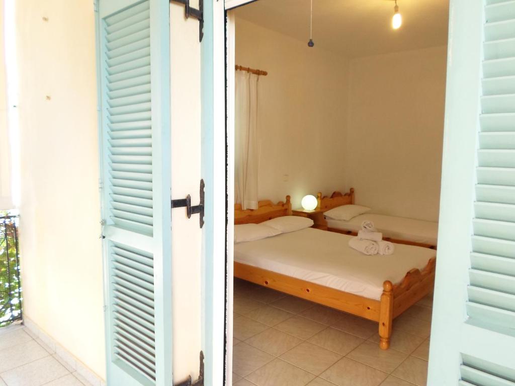 a bedroom with a bed and a window at Katerina Apartments in Tsoukaladhes