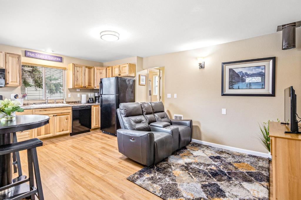 a living room with a chair and a kitchen at Bungalow on Boyd in Coeur d'Alene