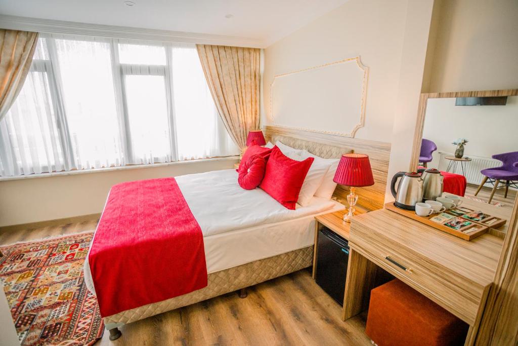 A bed or beds in a room at Gülec Konak Hotel