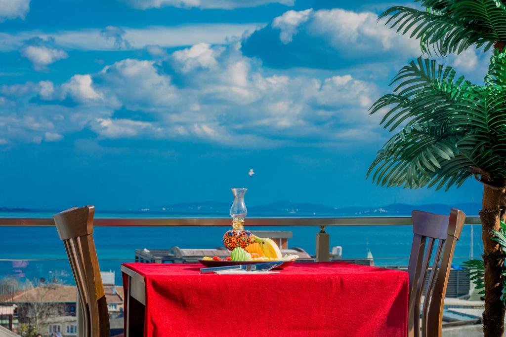 a table with a bowl of fruit on a red table cloth at Gülec Konak Hotel in Istanbul