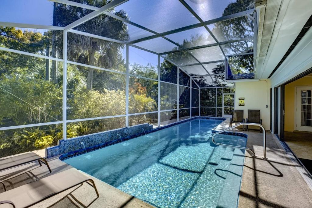a large swimming pool with a large window at Avenida Sanctuary in Siesta Key