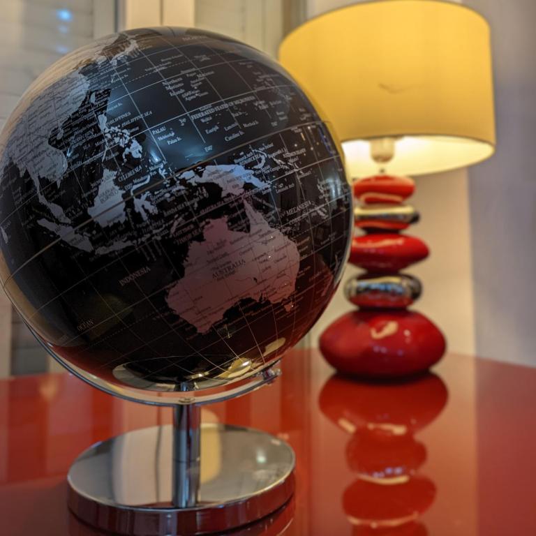 a globe on a table next to a lamp at Villa Pina Lumbarda in Lumbarda