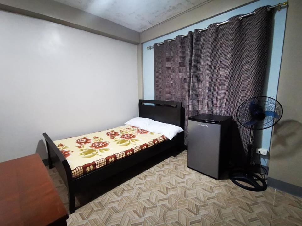 a bedroom with a bed and a television in it at BAGUIO Betty's Room Rental Couple Studio in Baguio
