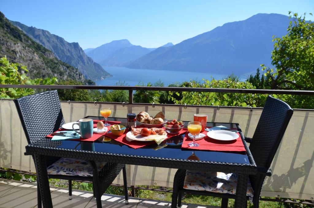 a black table with food on top of a balcony at Ferienwohnung-Casa-Uta-Gardasee-Limone-Tremosine in Tremosine Sul Garda