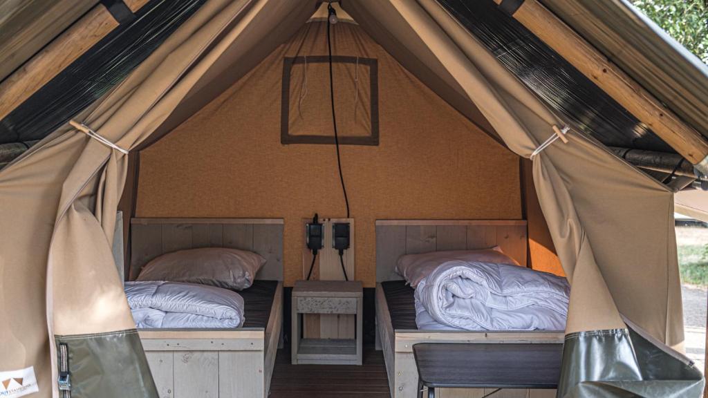 a couple of beds in a canvas tent at Safari tent XS in Berdorf