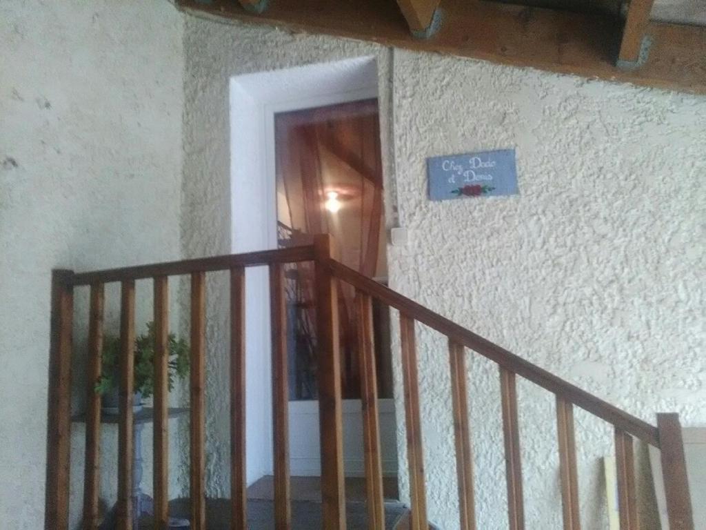 a staircase leading to a door in a house at Gîte Chez Dado &amp; Denis Saint Martin d&#39;Ardèche in Saint-Martin-dʼArdèche