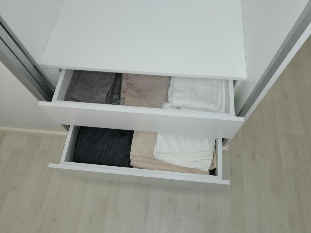 a closet with white shelves in a room at Home Beach in Figueira da Foz