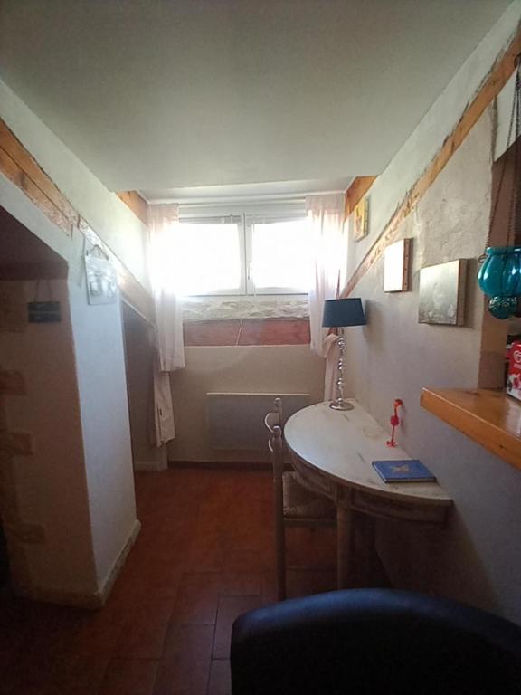 a small room with a table and a window at Gîte Chez Dado &amp; Denis Saint Martin d&#39;Ardèche in Saint-Martin-dʼArdèche