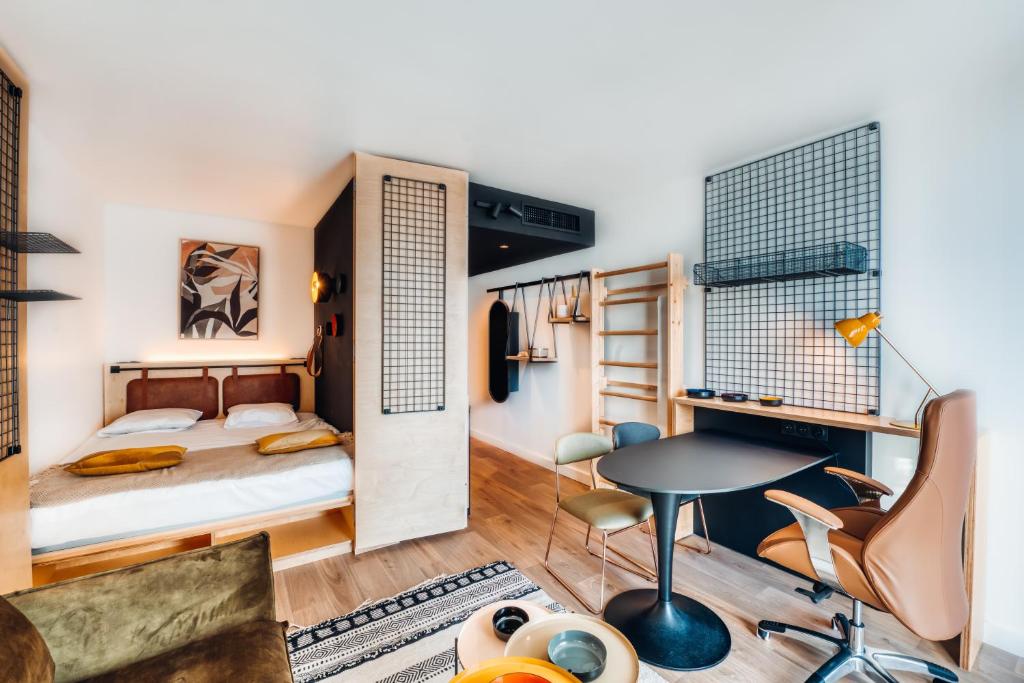 a bedroom with a bed and a desk and a table at COWOOL AVIGNON in Avignon