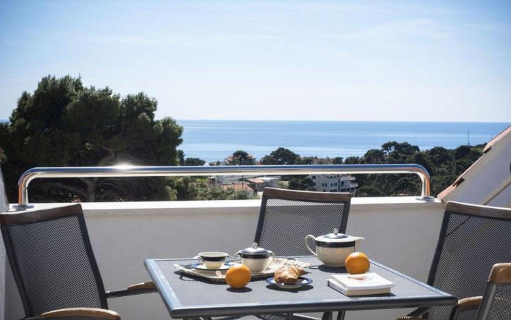 una mesa en un balcón con vistas al océano en Apartments Milka & Miho, en Dubrovnik