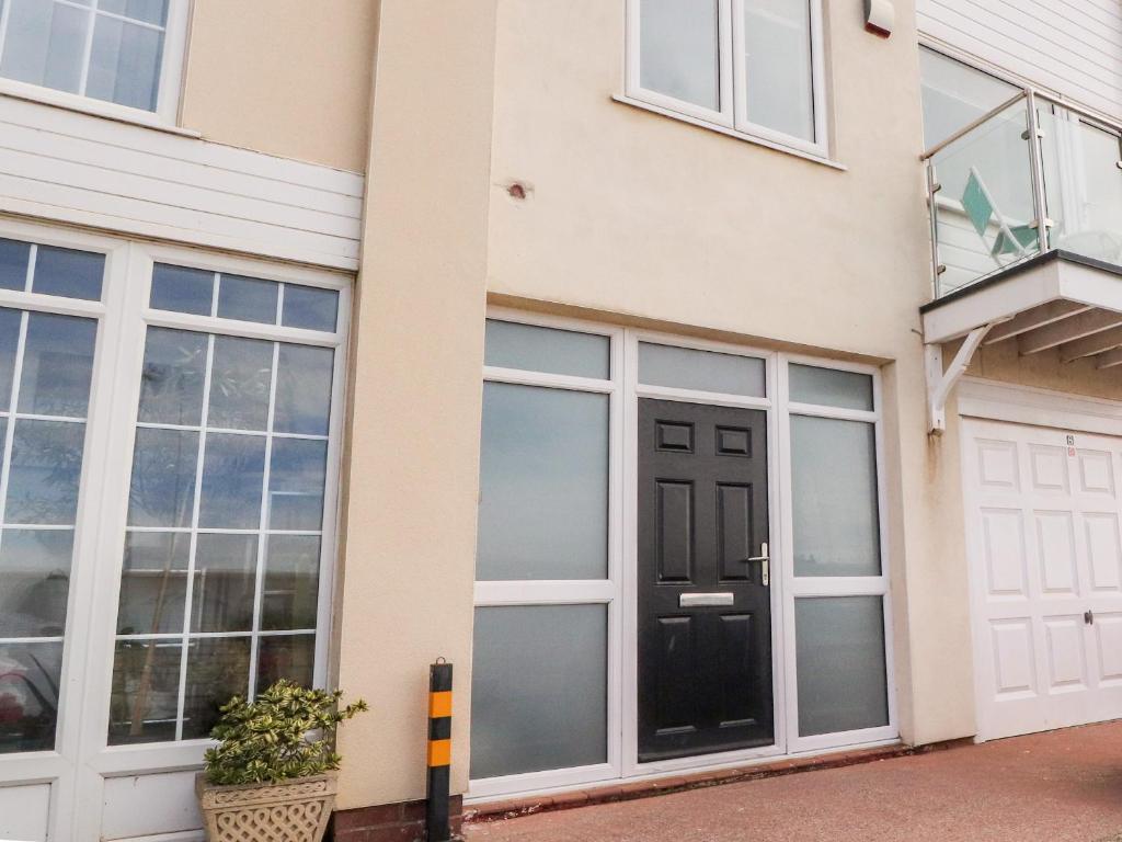 a house with large windows and a black door at The Beach House in Cleveleys