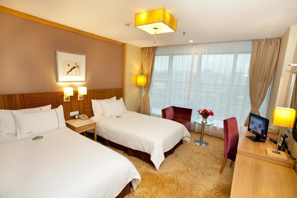 Postel nebo postele na pokoji v ubytování Liuhua Hotel