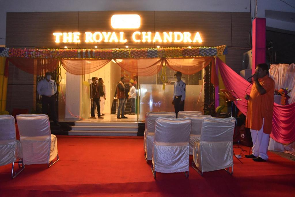 a room with white chairs and a sign that reads the royal chania at The Royal Chandra in Samastīpur