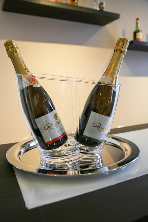 two bottles of champagne in a holder on a counter at INATEL Caparica in Costa da Caparica