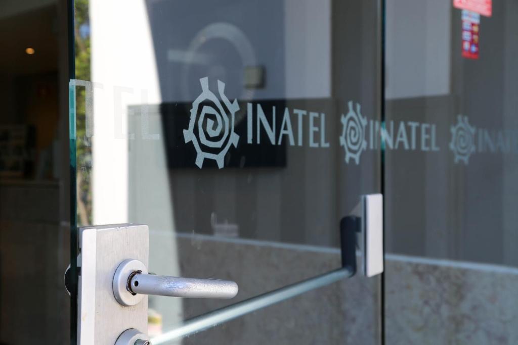 a door with a metal handle in front of a building at INATEL Caparica in Costa da Caparica