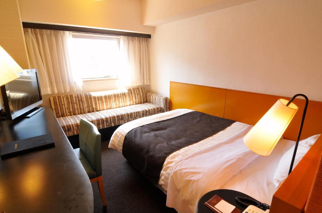 מיטה או מיטות בחדר ב-Hotel Listel Shinjuku