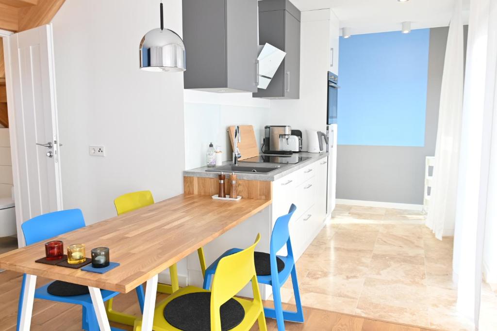 a kitchen with a wooden table and chairs at Ferienwohnung Rote Kate in Born