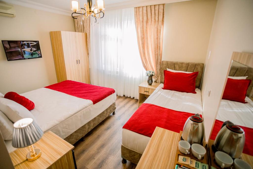 A bed or beds in a room at Gülec Konak Hotel