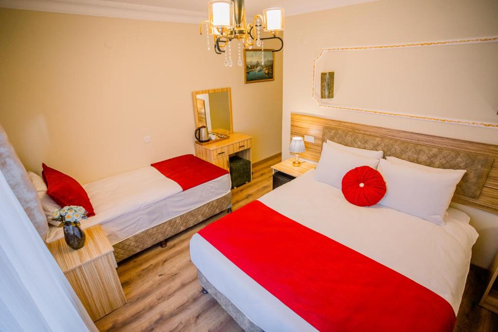 A bed or beds in a room at Gülec Konak Hotel