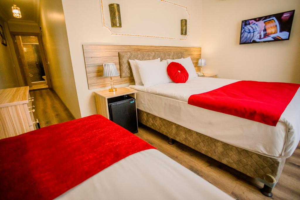 A bed or beds in a room at Gülec Konak Hotel
