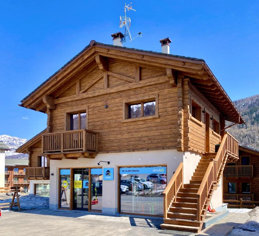 a log building with a store in front of it at Carosello Lodge Livigno in Livigno
