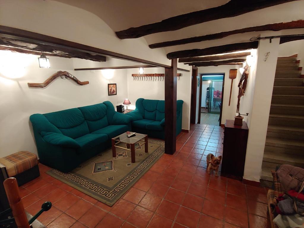 sala de estar con sofá verde y mesa en Casa Rural Sarrion casa completa 3 habitaciones y cocina, en Teruel