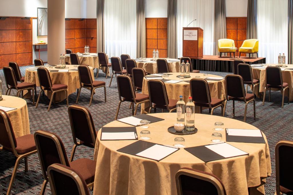 a conference room with round tables and chairs at Crowne Plaza Hotel Brugge by IHG in Bruges