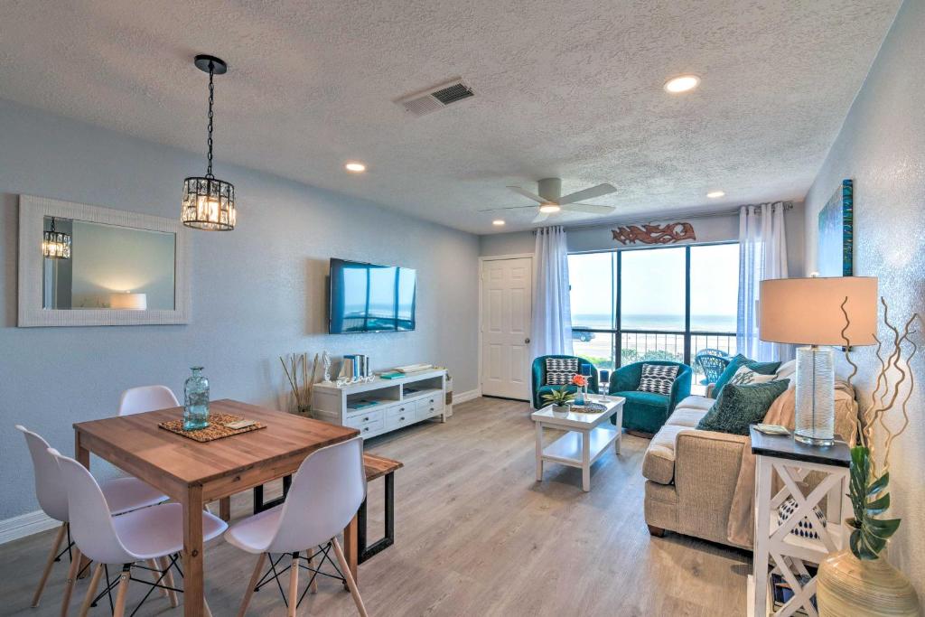a living room with a couch and a table with chairs at Ocean-View Balcony: Family Gem on Seawall Blvd! in Galveston