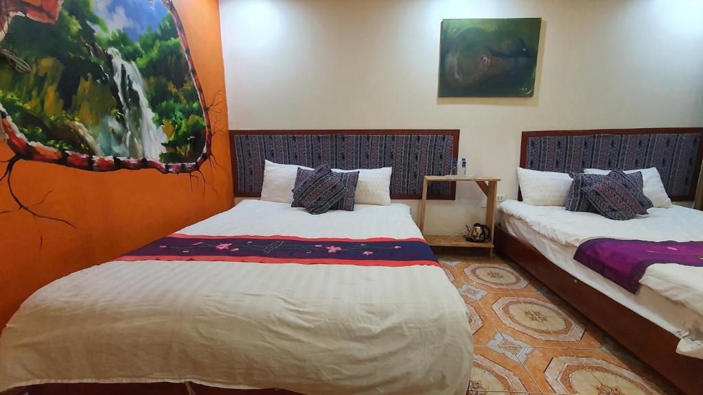 a room with two beds in a room at TRUC LAM HOTEL in Lao Cai