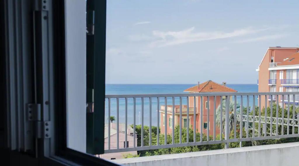 a window with a view of the ocean from a balcony at 010 - Sant Anna loft VISTA MARE 150m dalla SPIAGGIA in Sestri Levante