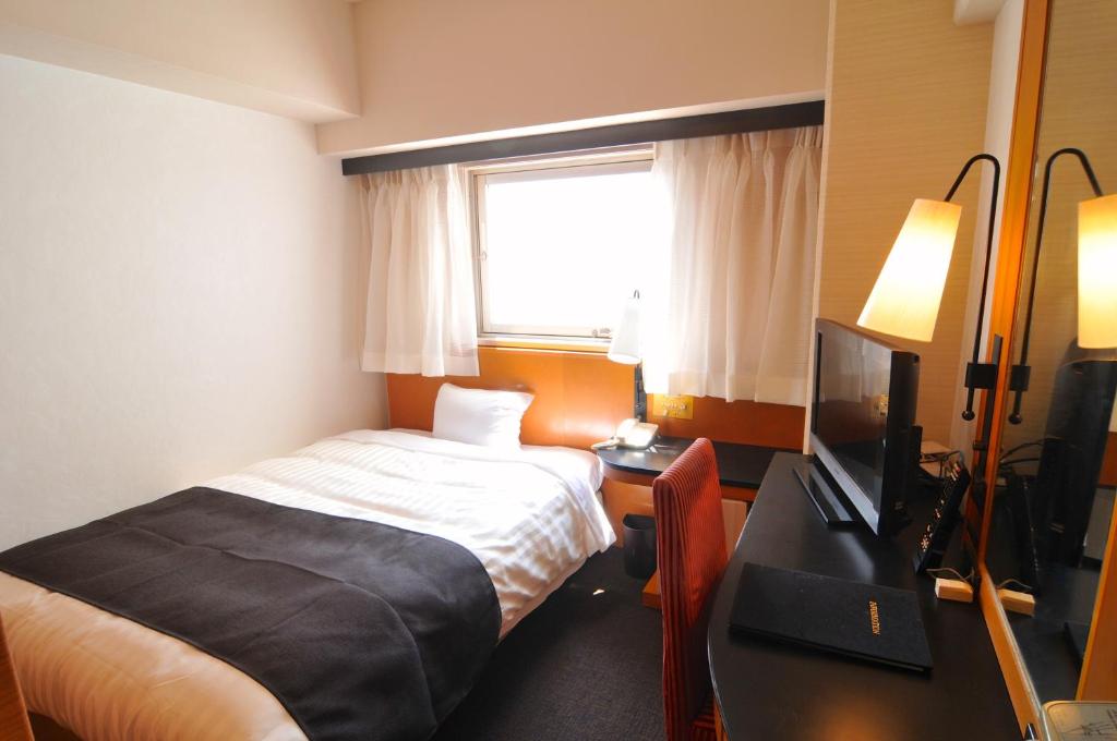 Postel nebo postele na pokoji v ubytování Hotel Listel Shinjuku