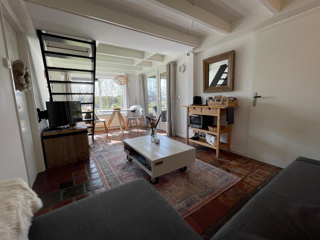 a living room with a couch and a coffee table at Slapen op het platteland in Bodegraven