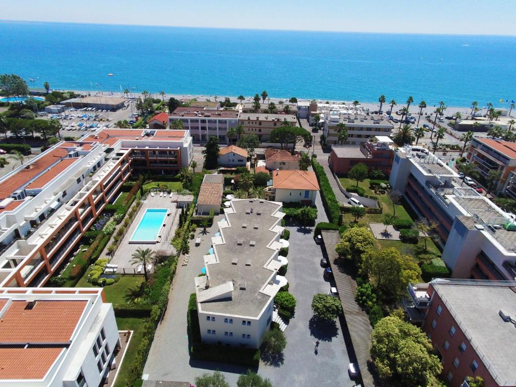 an aerial view of a city with buildings and the ocean at Hotel l'Etape in Villeneuve-Loubet