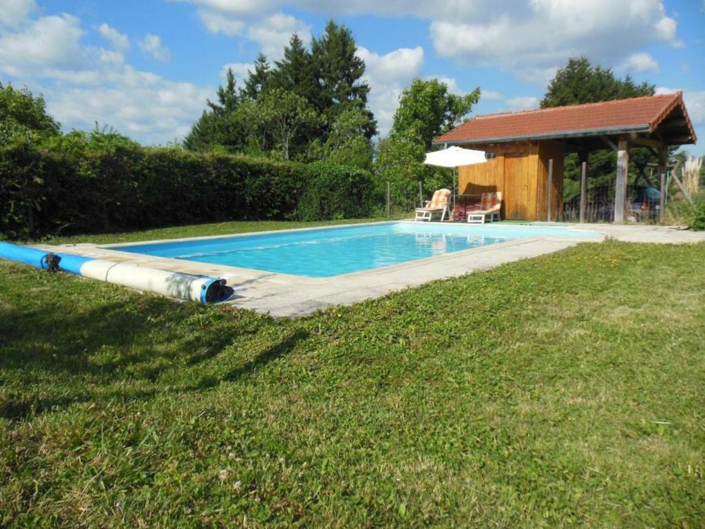 a swimming pool with a large tube next to a house at Gîte Renaison, 4 pièces, 6 personnes - FR-1-496-257 in Renaison