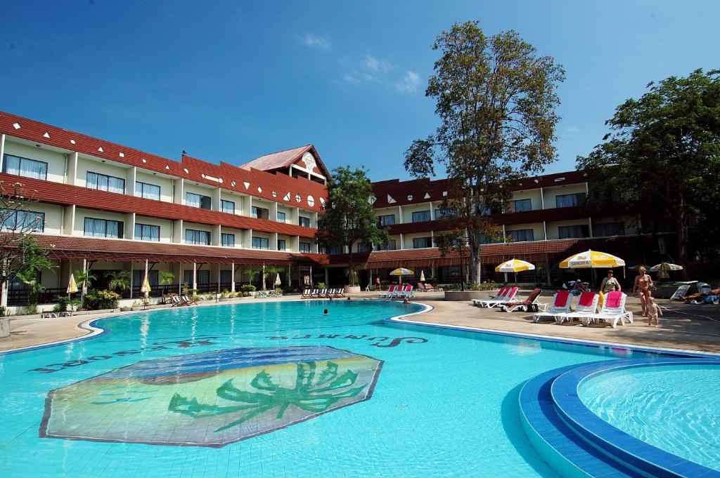 a large swimming pool in front of a hotel at Pattaya Garden Resort in North Pattaya