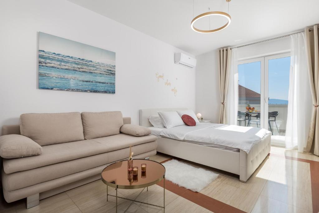 a living room with a couch and a table at Luxury Studio Apartment Honeymoon in Selce