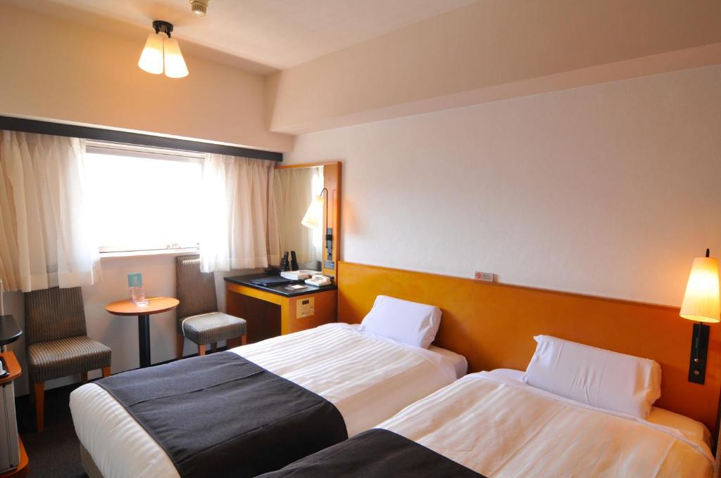 Postel nebo postele na pokoji v ubytování Hotel Listel Shinjuku
