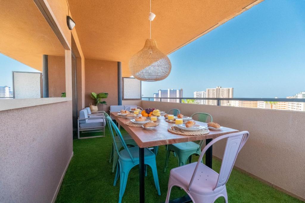 a table and chairs on a balcony with a view at Relax in Paraiso by Olax Rentals in Playa Paraiso
