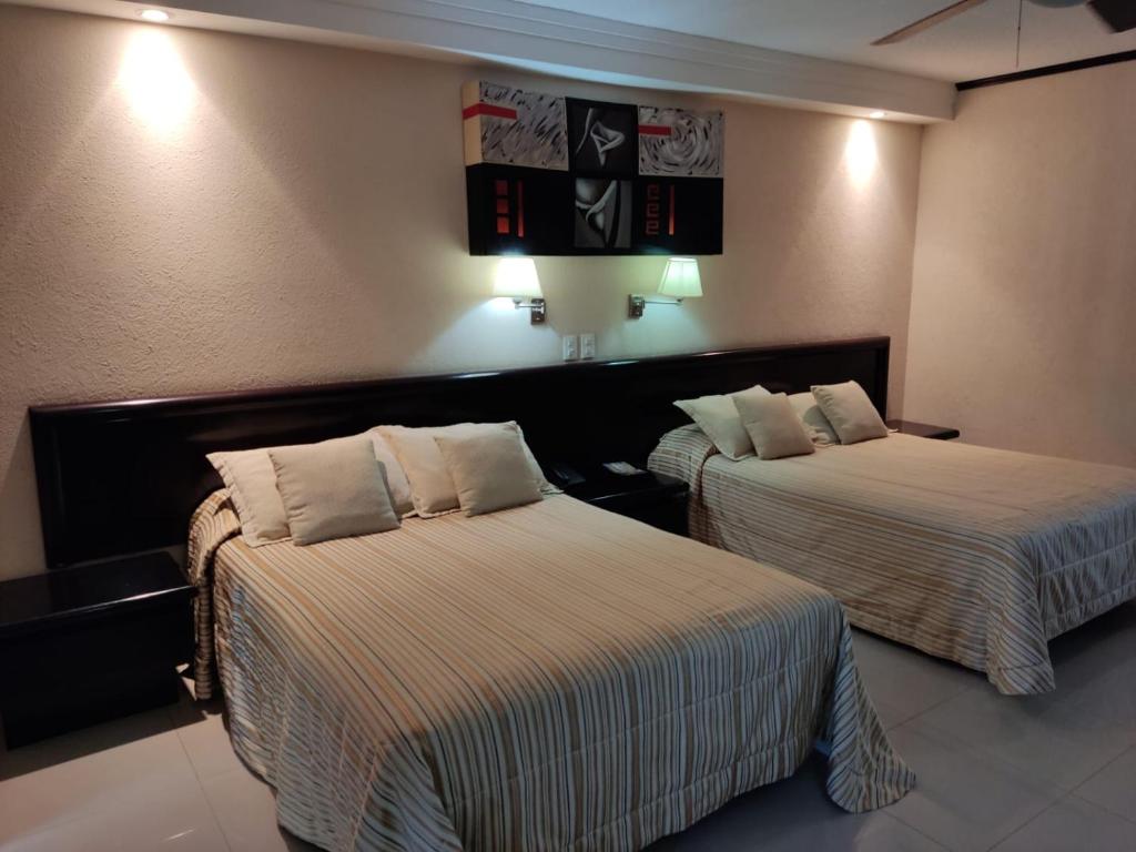 Postel nebo postele na pokoji v ubytování Hotel Mary Celaya