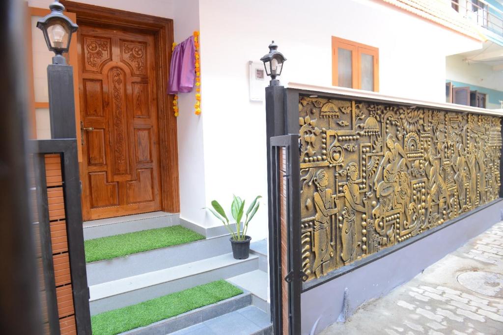 a gate in front of a house with a door at Ekana Homes in Trivandrum