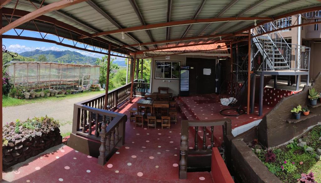 a patio with a table and chairs in a building at Sinurambi 2 in Kundasang