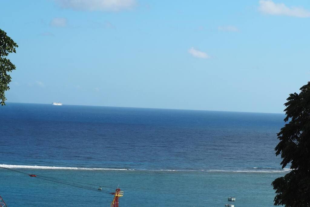 a view of a body of water with a lighthouse at Coastal Beauty - Beautiful Penthouse Condo in Ocho Rios in Ocho Rios