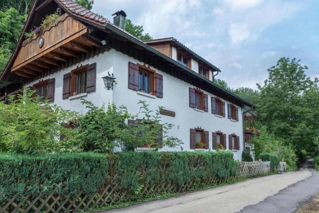 a white house with a wooden roof at Landhaus - In der hohen Eich Dg in Überlingen