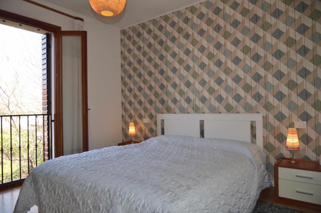 Łóżko lub łóżka w pokoju w obiekcie Montello Apartment Noale