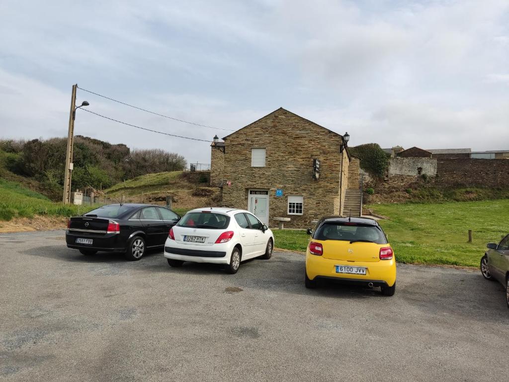 a group of three cars parked in a parking lot at OS MUIÑOS in Ribadeo