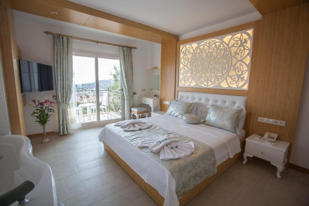 Postel nebo postele na pokoji v ubytování Hotel Aysima