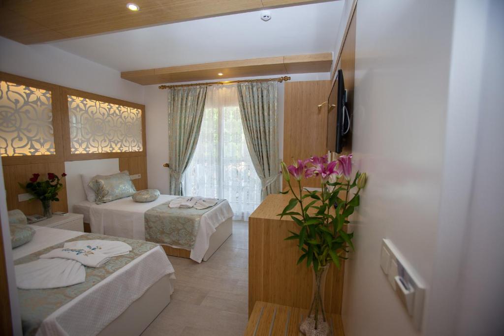 Postel nebo postele na pokoji v ubytování Hotel Aysima