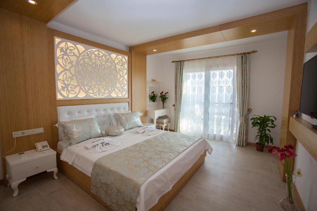 Postel nebo postele na pokoji v ubytování Hotel Aysima