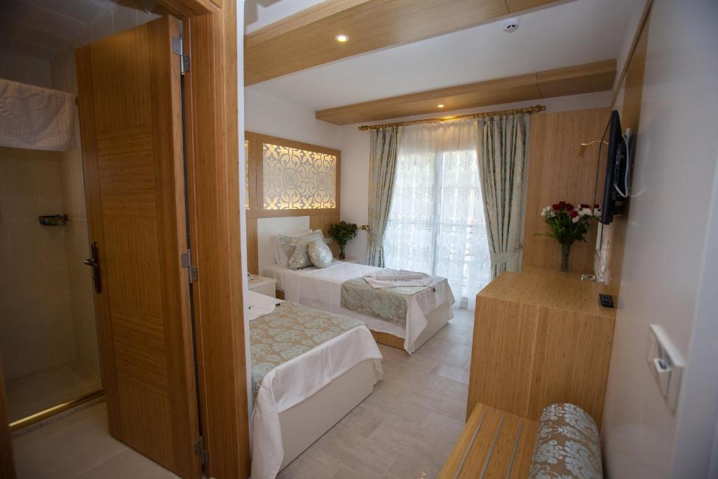 Postel nebo postele na pokoji v ubytování Hotel Aysima