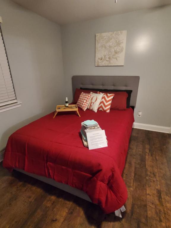 a bedroom with a red bed with a red blanket at Spacious Atlanta 2Bedroom/ 2Full Baths Renovated in Atlanta